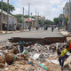 Children play near a road destroyed by rain water that flooded their street in Mogadishu, Somalia May 21, 2018.